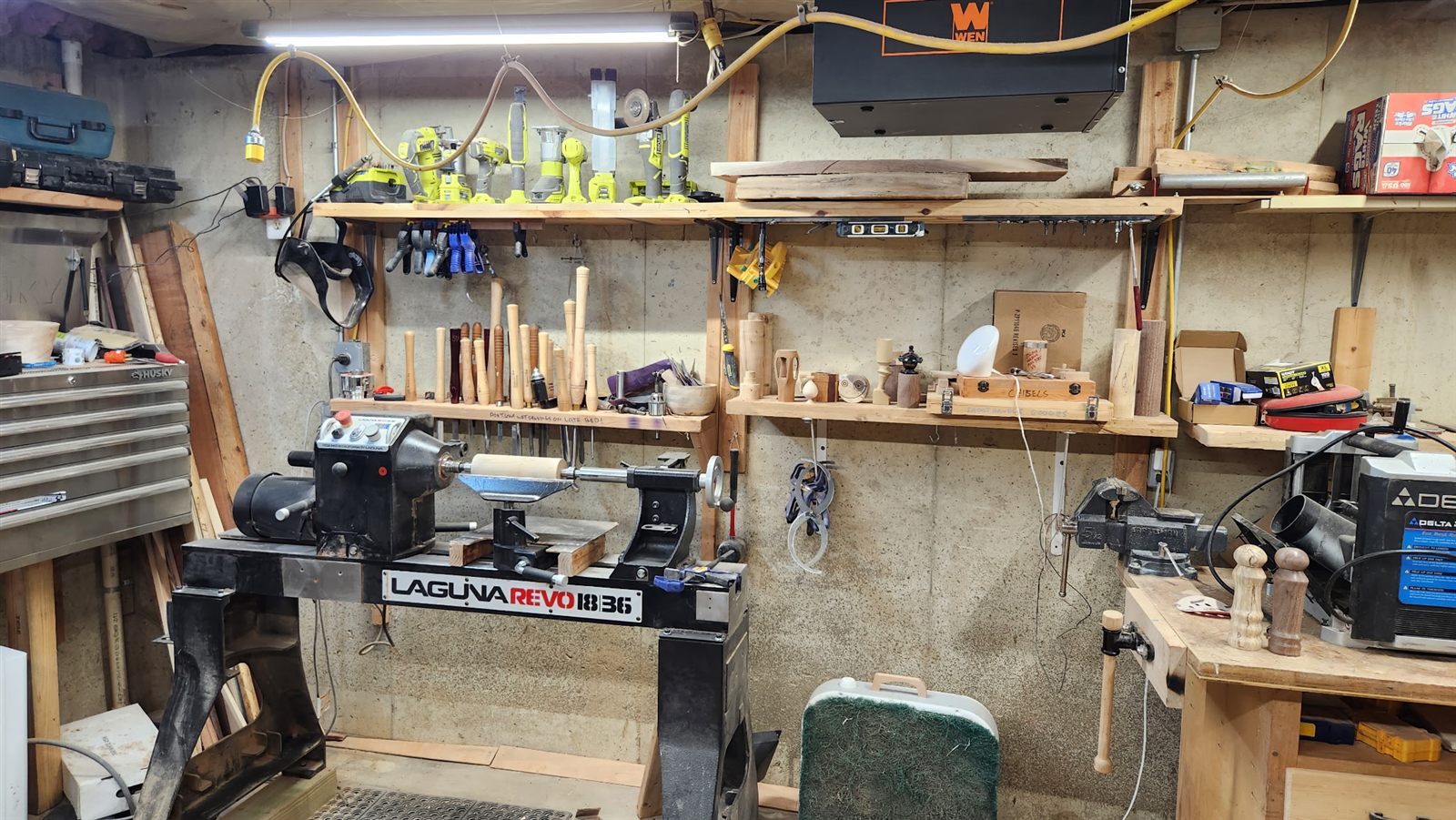 The lathe wall of the workshop, turning tools racked above the Laguna lathe