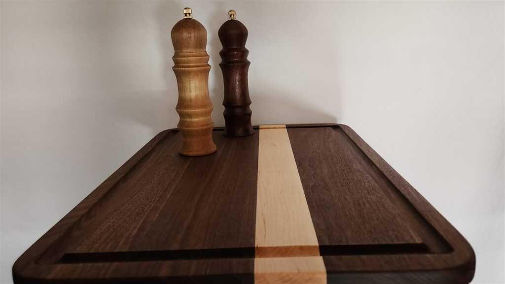 The pair of mills in walnut and spalted maple on a cutting board