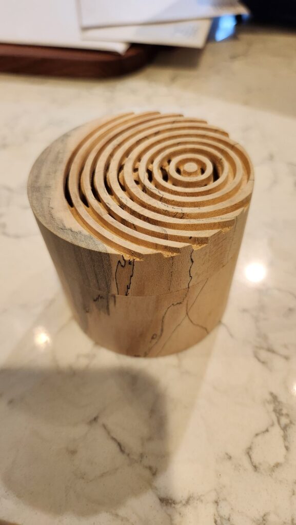 The box angled on a counter, rings casting shadows