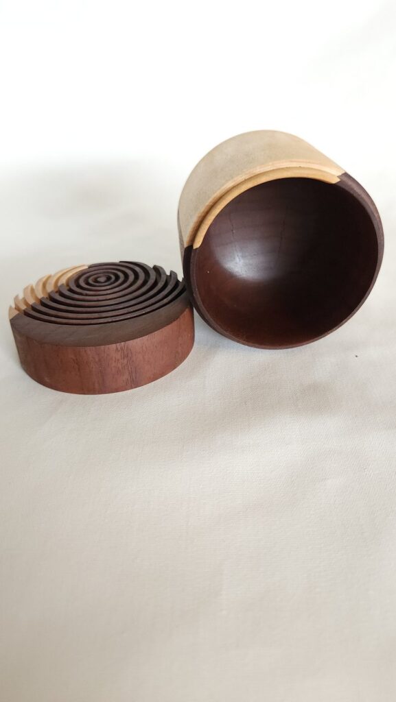 The box open with the spiral lid resting against it
