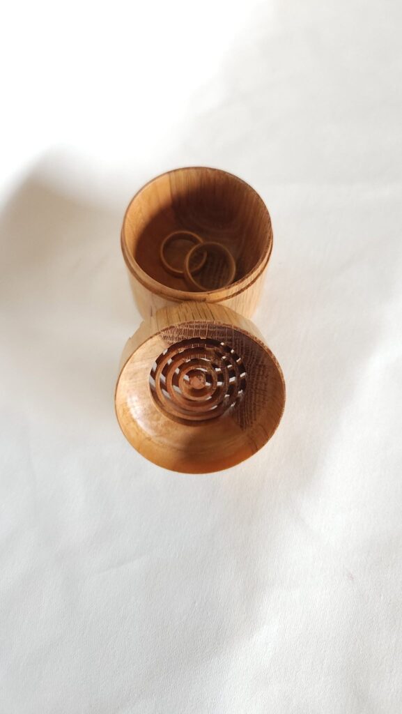 The ring-cut lid leaning against the open body